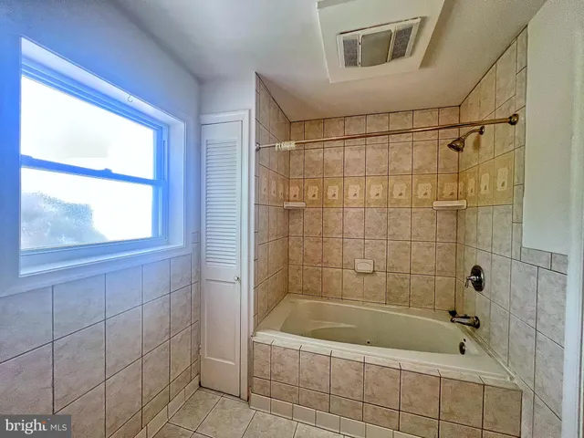 a bathroom with a shower and bathtub