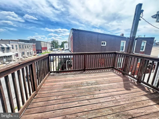 a view of balcony with wooden floor and fence