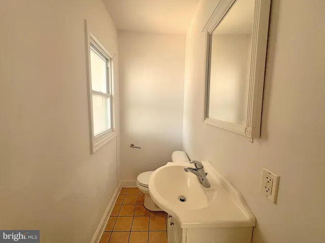 a bathroom with a sink and a window