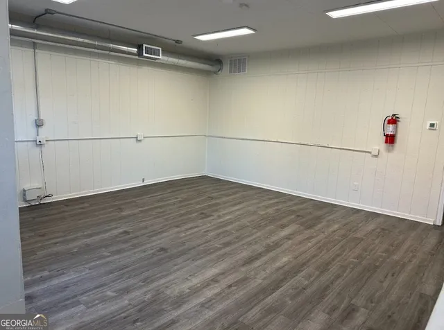 a view of a room with wooden floor