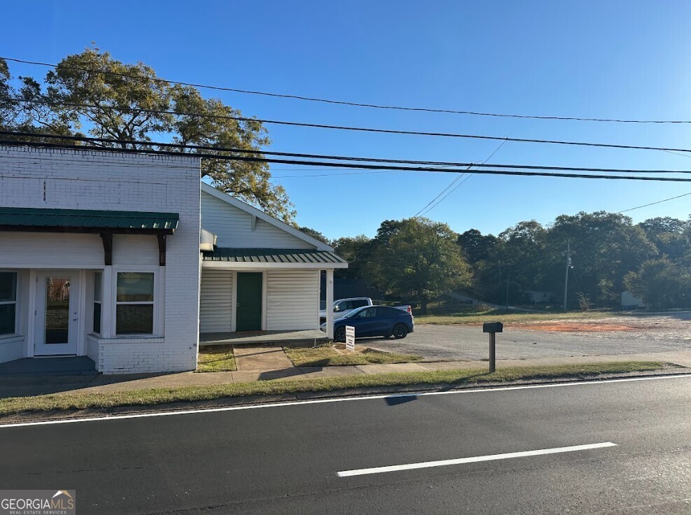 824-828 South Broad Street Commerce, GA 30529 - Photo 2 of 17 a view of a building with a road from a living room