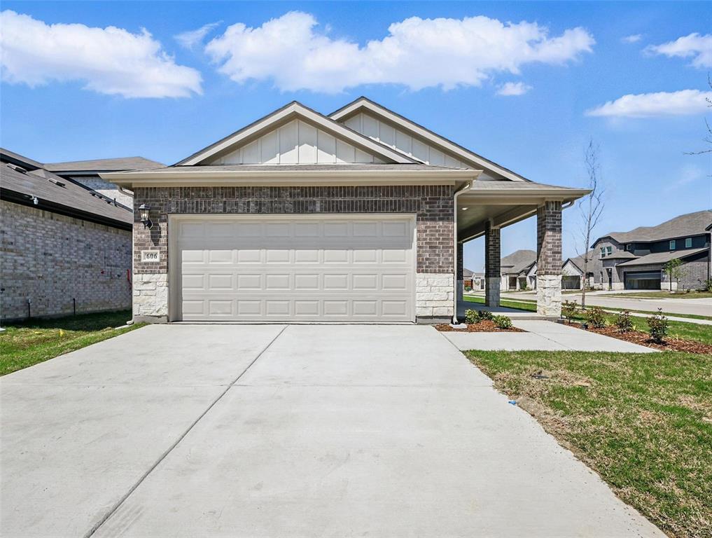 606 Ezra Lane McKinney, TX 75069 - Photo 1 of 1 View of front of house with an attached garage, board and batten siding, concrete driveway, and stone siding