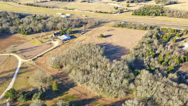 a view of a yard with a wooden fence