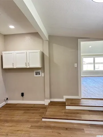 a view of room with window and wooden floor