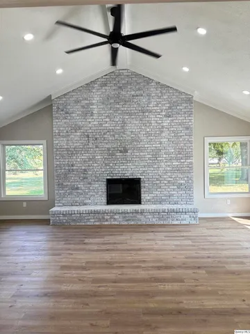 a view of a livingroom with a fireplace and a window