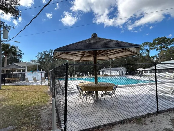 a view of swimming pool with a yard and sitting area