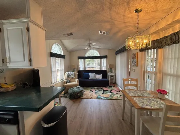a living room with furniture and a chandelier