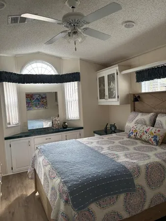 a bedroom with a large bed and a chandelier