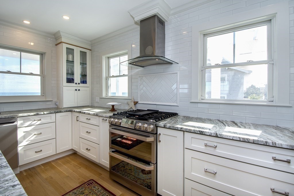 61 Seaside Road Scituate, MA 02066 - Photo 15 of 39 a kitchen with granite countertop a stove a sink and a window