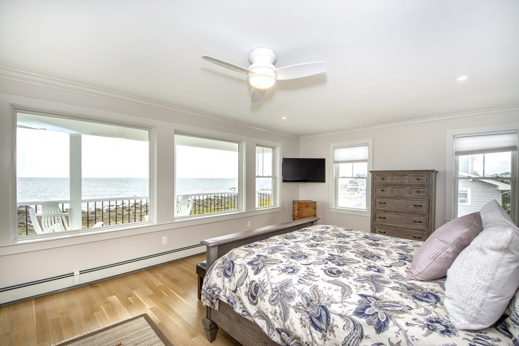 61 Seaside Road Scituate, MA 02066 - Photo 25 of 39 a bedroom with a large bed and a large window