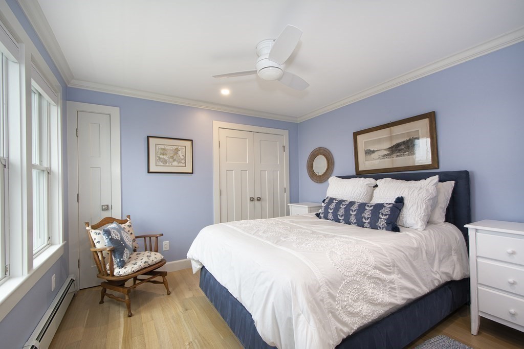 61 Seaside Road Scituate, MA 02066 - Photo 27 of 39 a bedroom with a bed and wooden floor