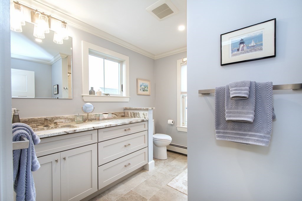 61 Seaside Road Scituate, MA 02066 - Photo 29 of 39 a bathroom with a granite countertop sink mirror vanity and toilet
