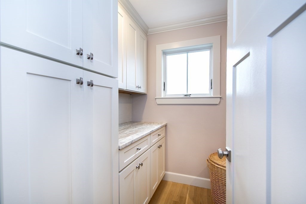 61 Seaside Road Scituate, MA 02066 - Photo 30 of 39 a view of a kitchen with white cabinets and sink