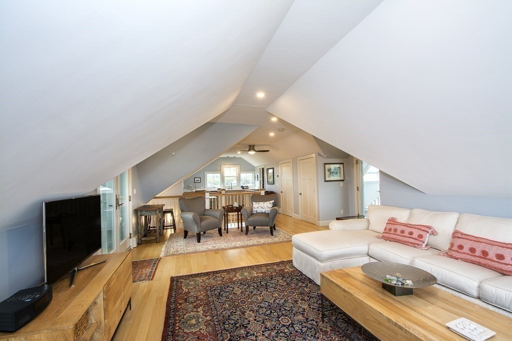 61 Seaside Road Scituate, MA 02066 - Photo 33 of 39 a living room with furniture and a dining table