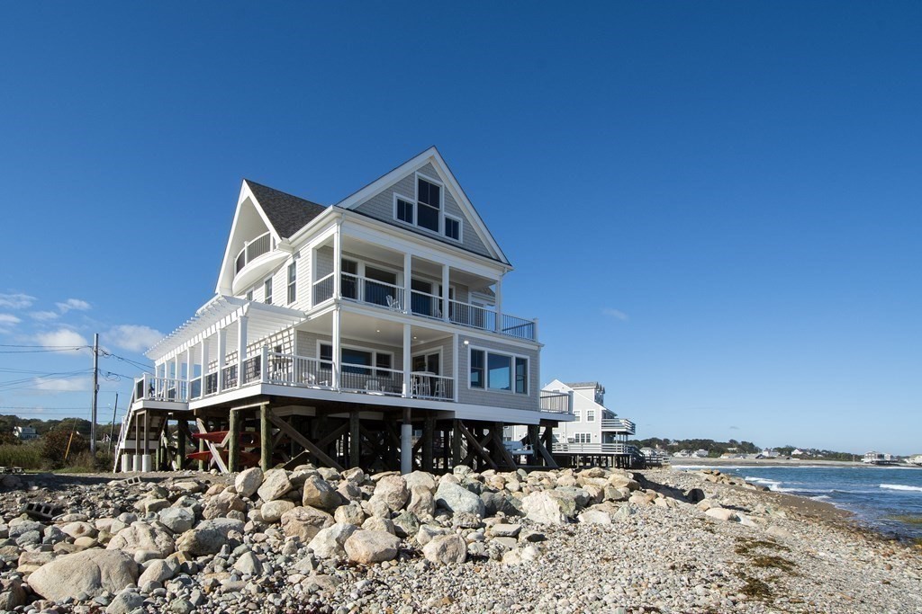 61 Seaside Road Scituate, MA 02066 - Photo 4 of 39 a front view of a house with a yard covered in snow