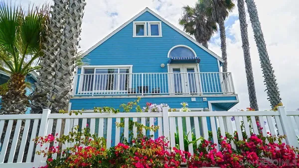 a view of a wooden house with a wooden fence