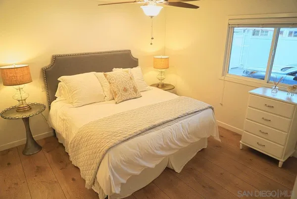 a large bed sitting in a bedroom next to a window