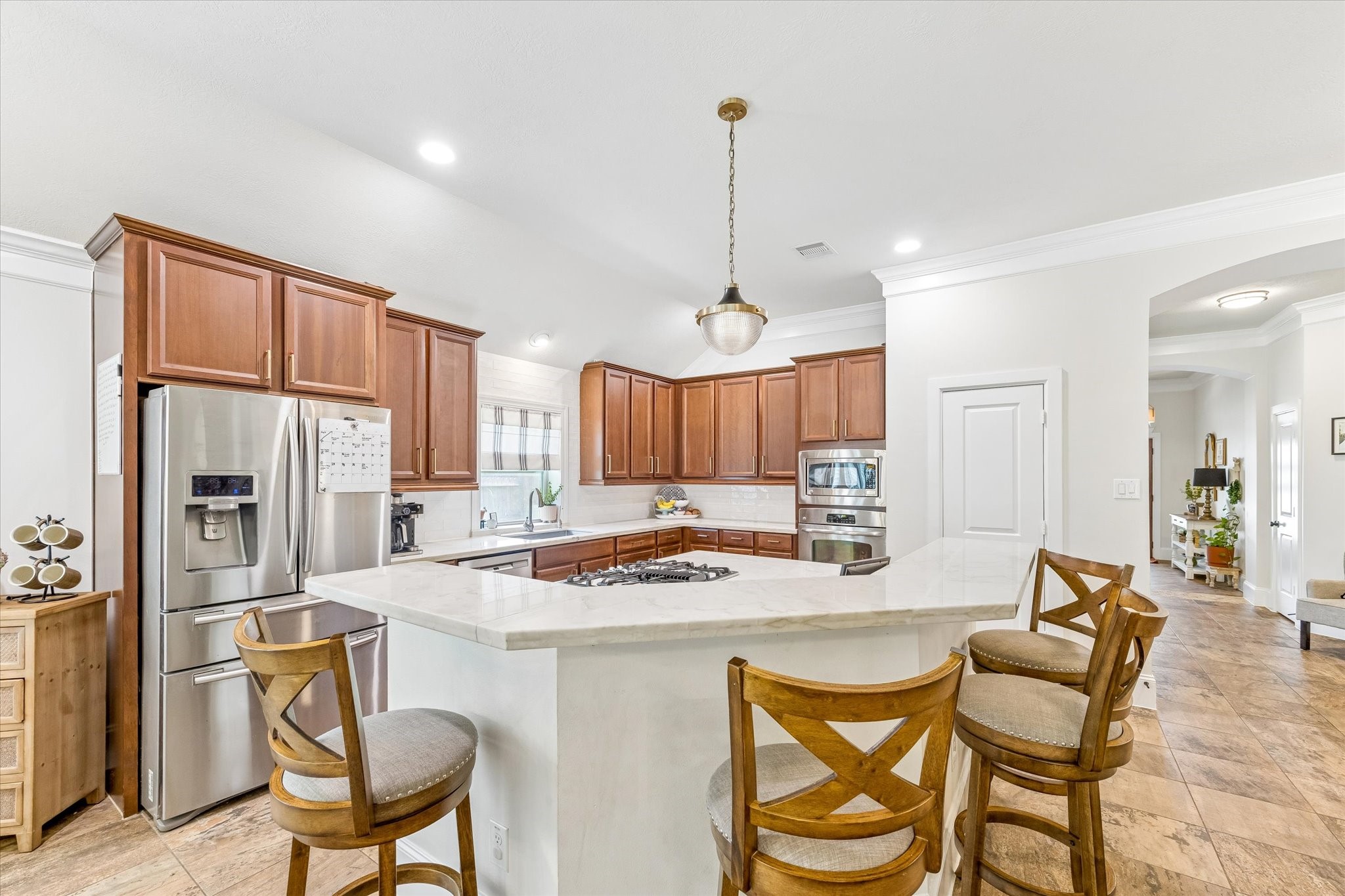 31306 Brighton Brook Lane Spring, TX 77386 - Photo 8 of 34 Chef-inspired kitchen featuring a large center island, extensive cabinetry, and ample seating.
