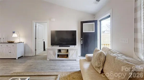 a living room with furniture and a flat screen tv