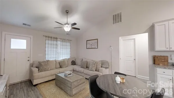 a living room with furniture and a chandelier