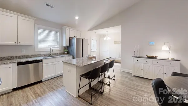 a kitchen with sink cabinets and wooden floor