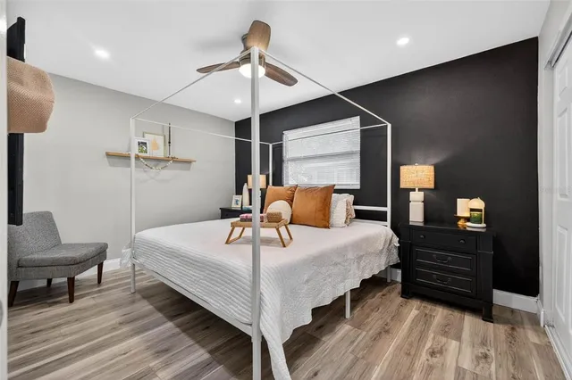 a bedroom with a bed and a chandelier