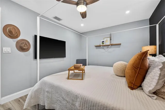 a bedroom with a bed and a chandelier