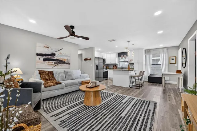 a living room with furniture and kitchen view