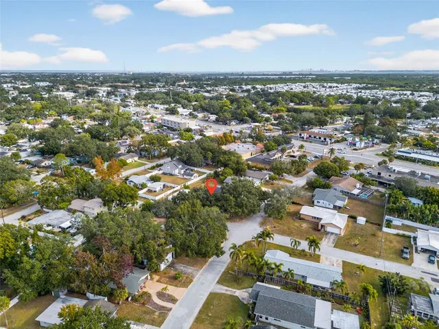 an aerial view of residential houses with city view