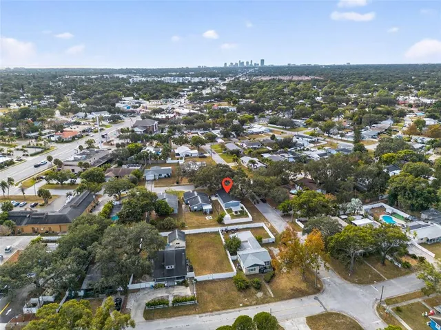 an aerial view of residential houses with city view