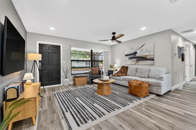 a living room with furniture and a wooden floor