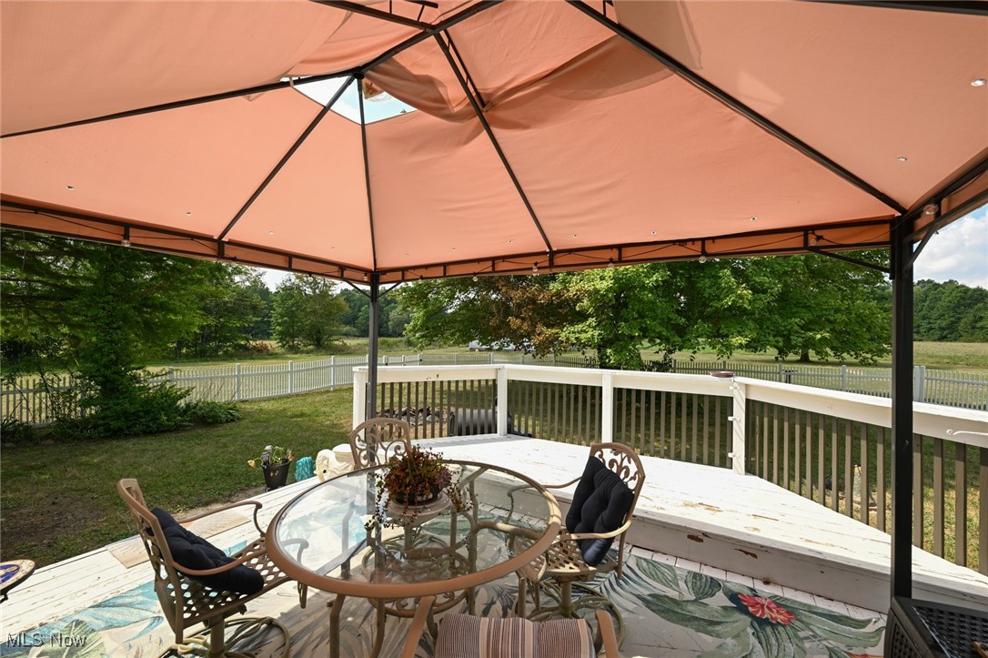 2757 Porter Road Atwater, OH 44201 - Photo 36 of 49 Deck featuring a fenced backyard, outdoor dining space, and a gazebo