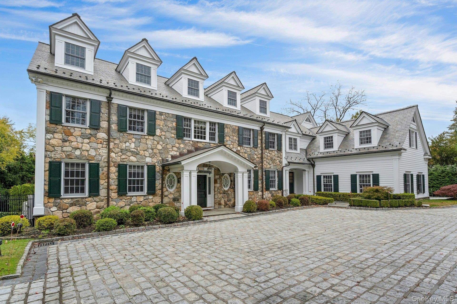 Welcome home to 1 Garden Road, Scarsdale. This exquisite stone front Colonial is situated in the estate section of Scarsdale on over one acre of landscaped grounds.