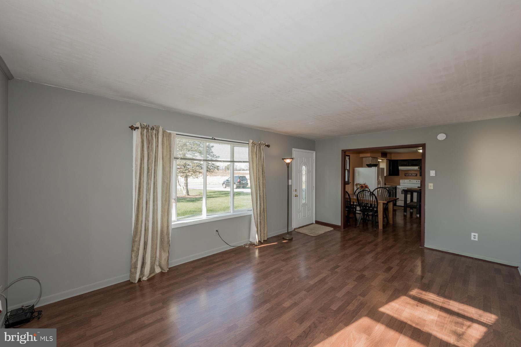 3569 Fringer Road Taneytown, MD 21787 - Photo 2 of 24 an empty room with wooden floor and a window