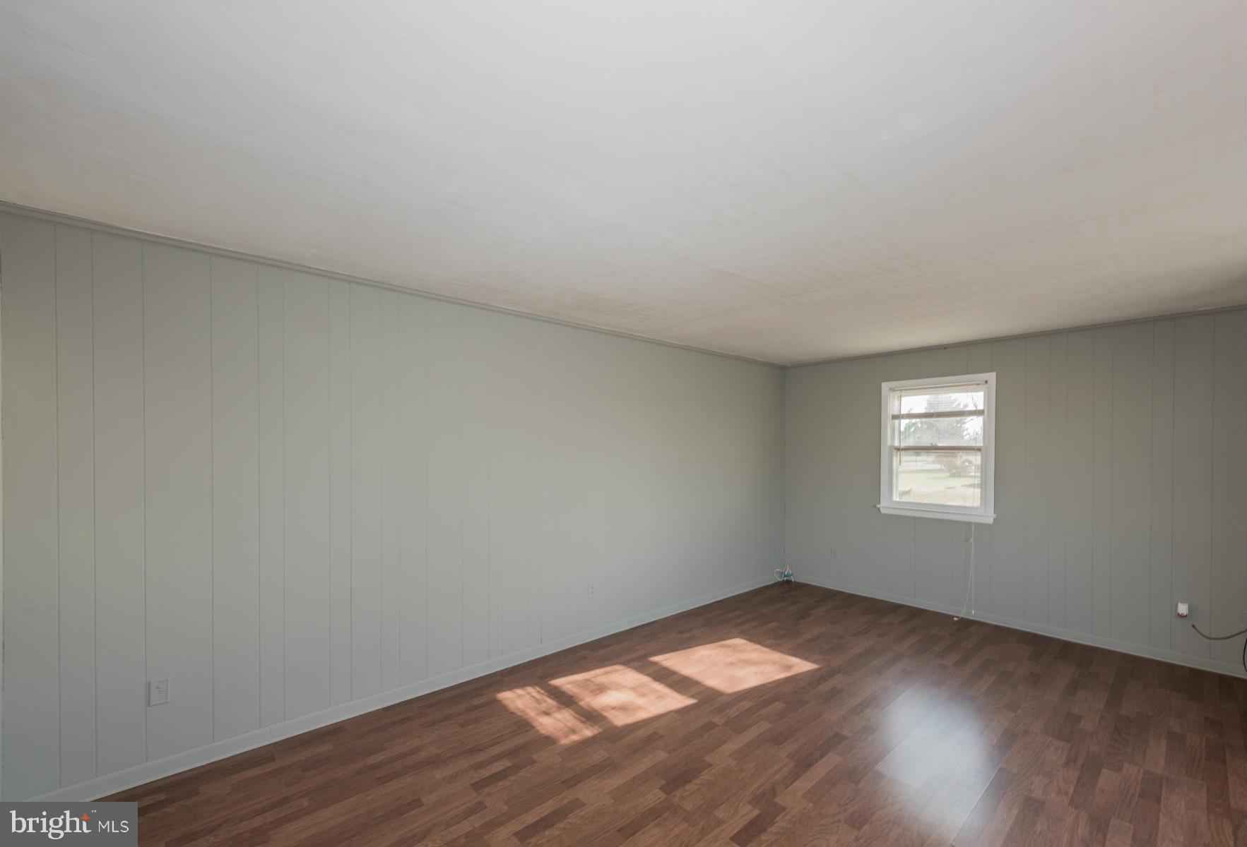 3569 Fringer Road Taneytown, MD 21787 - Photo 4 of 24 a view of empty room with wooden floor and fan