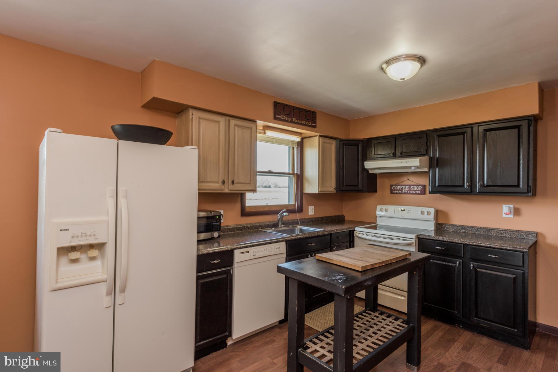 3569 Fringer Road Taneytown, MD 21787 - Photo 6 of 24 a kitchen with stainless steel appliances a refrigerator a stove a sink dishwasher and a refrigerator with wooden cabinets