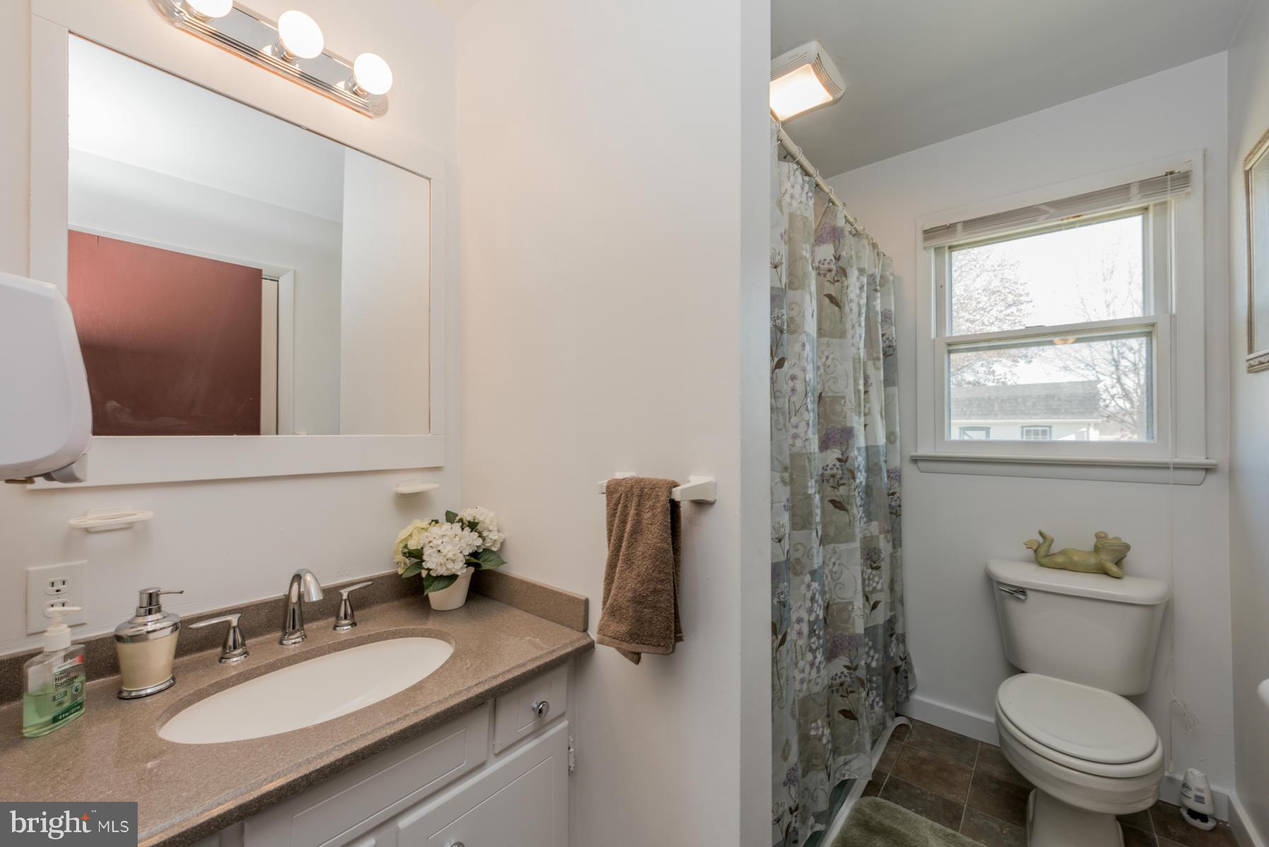 3569 Fringer Road Taneytown, MD 21787 - Photo 10 of 24 a bathroom with a granite countertop sink toilet and shower