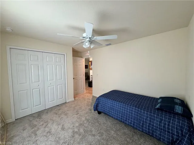 a kitchen with stainless steel appliances granite countertop a refrigerator a sink dishwasher a stove top oven a refrigerator and white cabinets with wooden floor