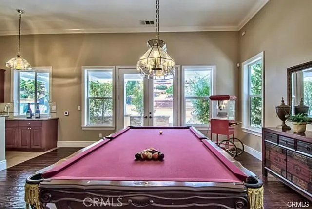 a room with furniture pool table and windows