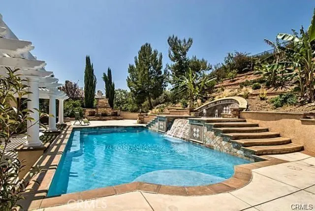 a view of a swimming pool with outdoor seating