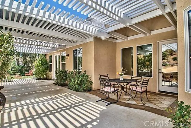 a view of a patio with table and chairs