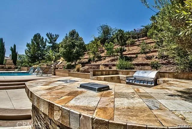 a terrace with a bench and trees