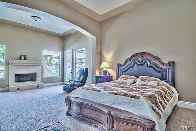 a bedroom with a bed and a fireplace