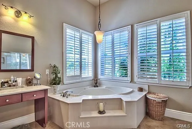 a bath tub sitting in a bathroom next to a window