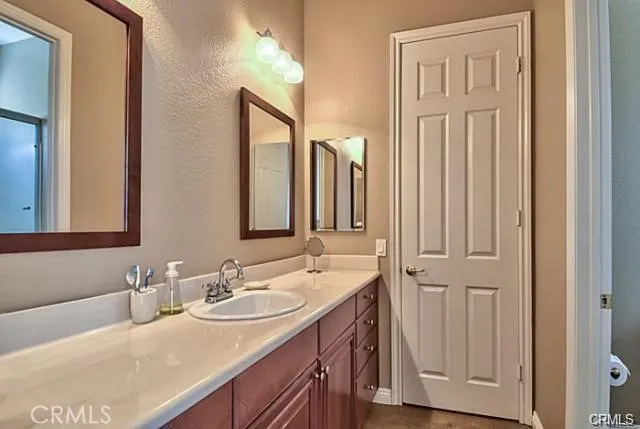 a bathroom with a sink vanity and a mirror