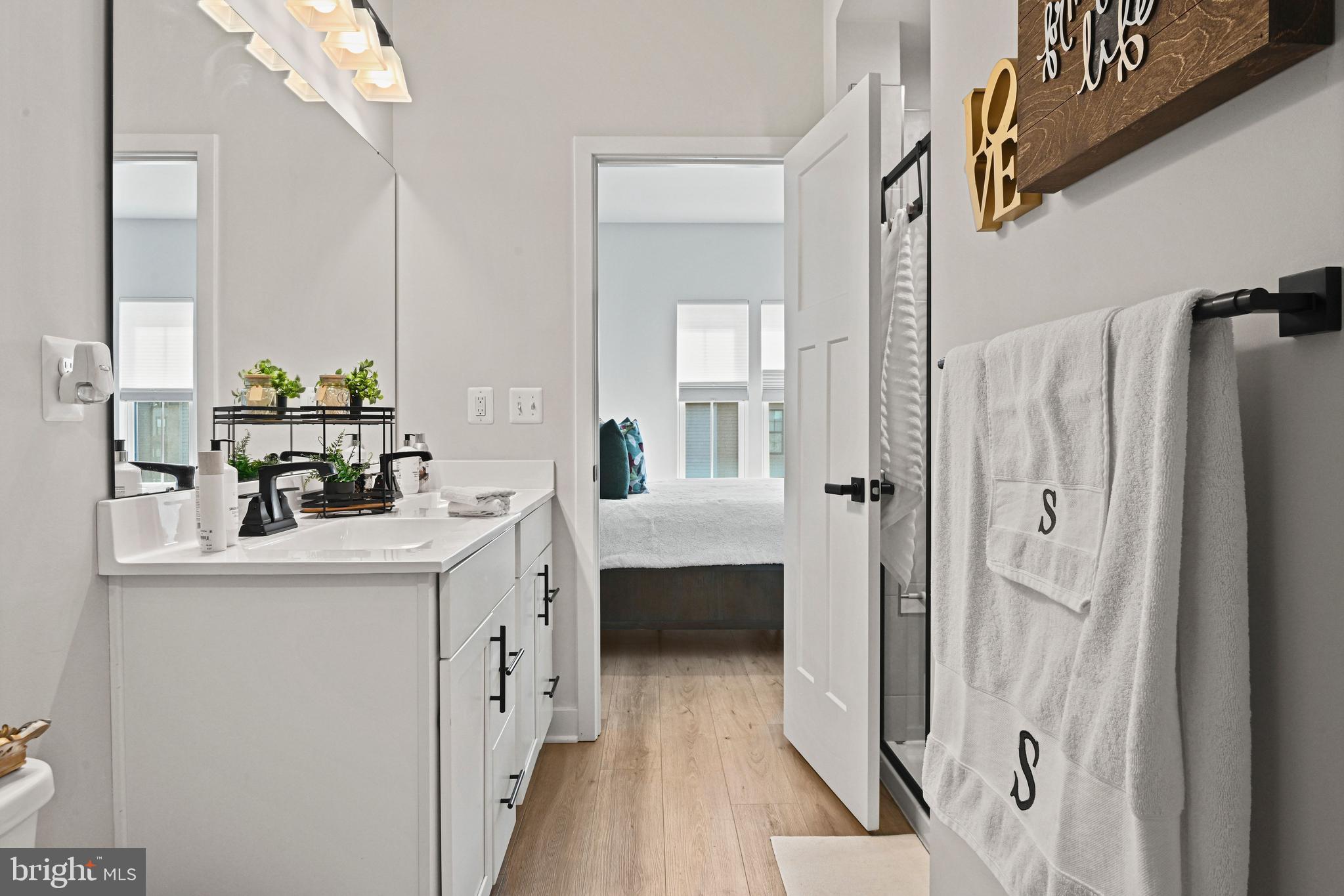 14008 Airfoil Road Herndon, VA 20171 - Photo 27 of 47 a bathroom with a double vanity sink a mirror a bathtub and shower