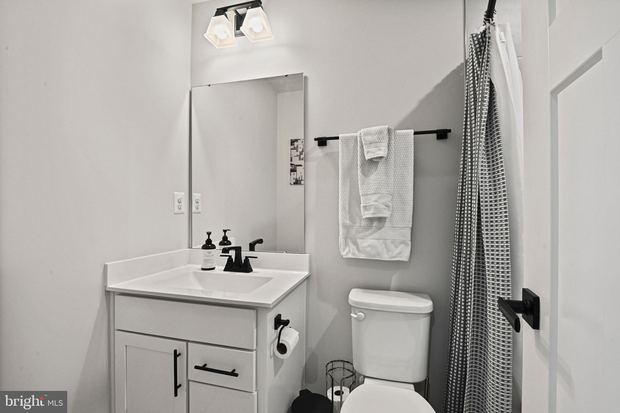 14008 Airfoil Road Herndon, VA 20171 - Photo 31 of 47 a bathroom with a sink a toilet a mirror and shower