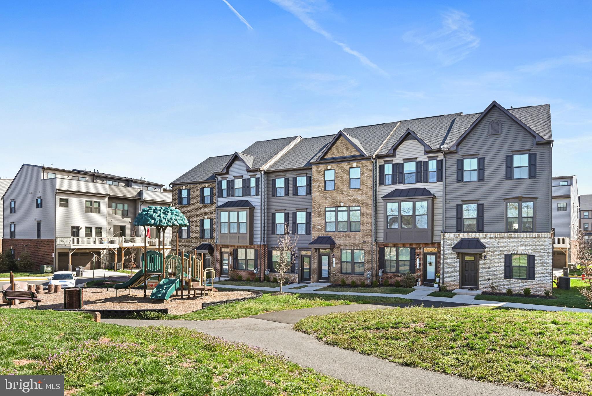14008 Airfoil Road Herndon, VA 20171 - Photo 4 of 47 a front view of a residential apartment building with a yard table and chairs