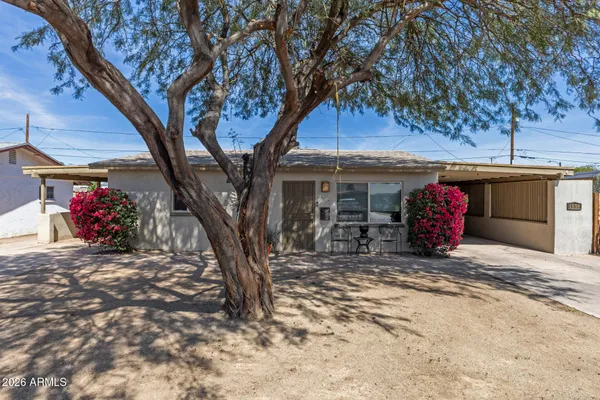 a view of a house with a snow and a tree