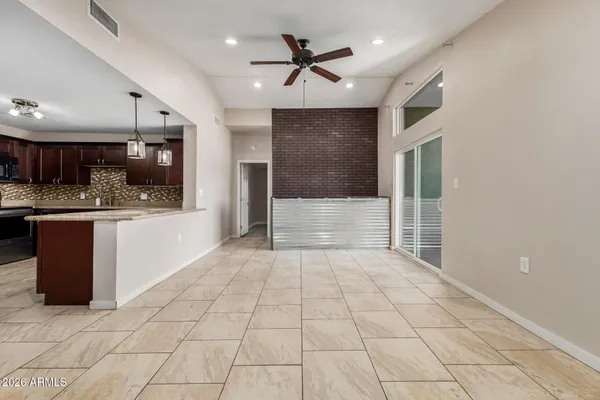 a view of kitchen with cabinets and window